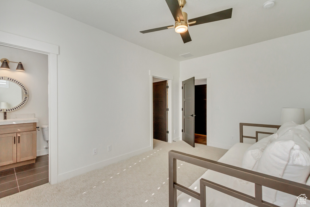Carpeted bedroom featuring baseboards and ensuite bathroom