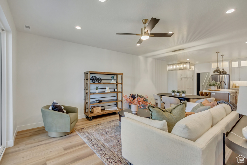 Living room with visible vents, recessed lighting, a ceiling fan, and light wood finished floors