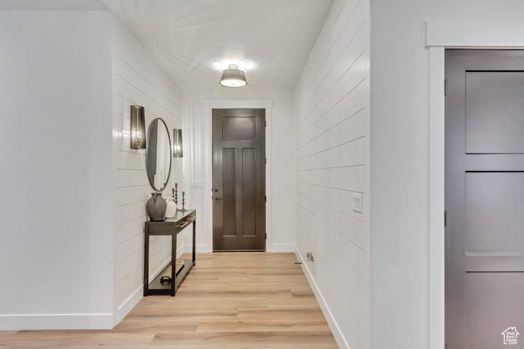 Corridor featuring baseboards and light wood finished floors