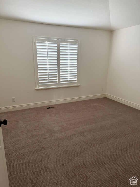 Spare room with carpet flooring, baseboards, and visible vents