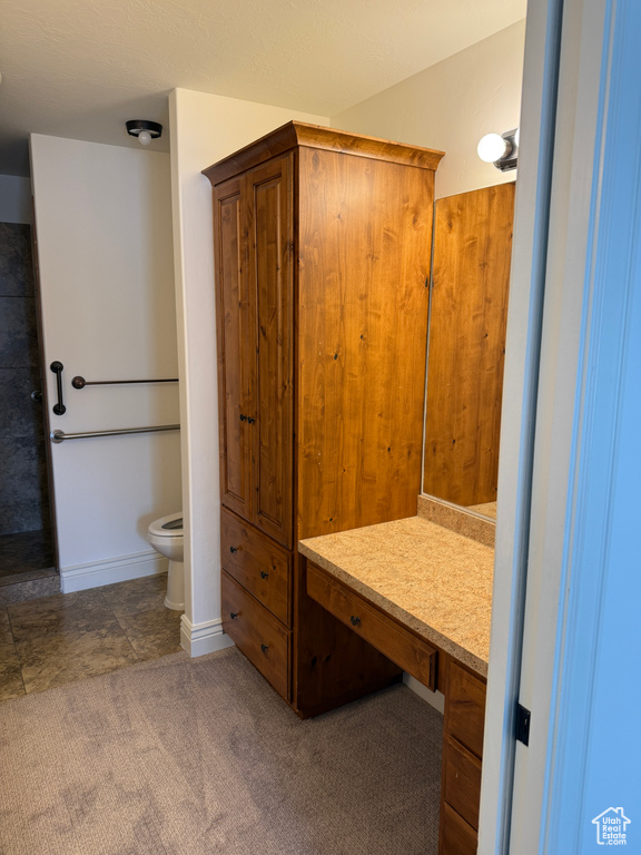 Bathroom featuring toilet and baseboards