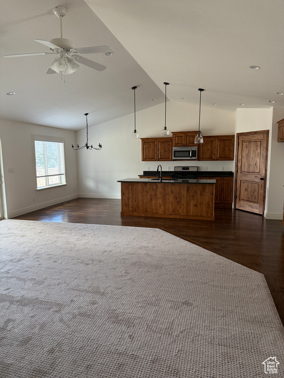 Kitchen with a sink, open floor plan, and appliances with stainless steel finishes