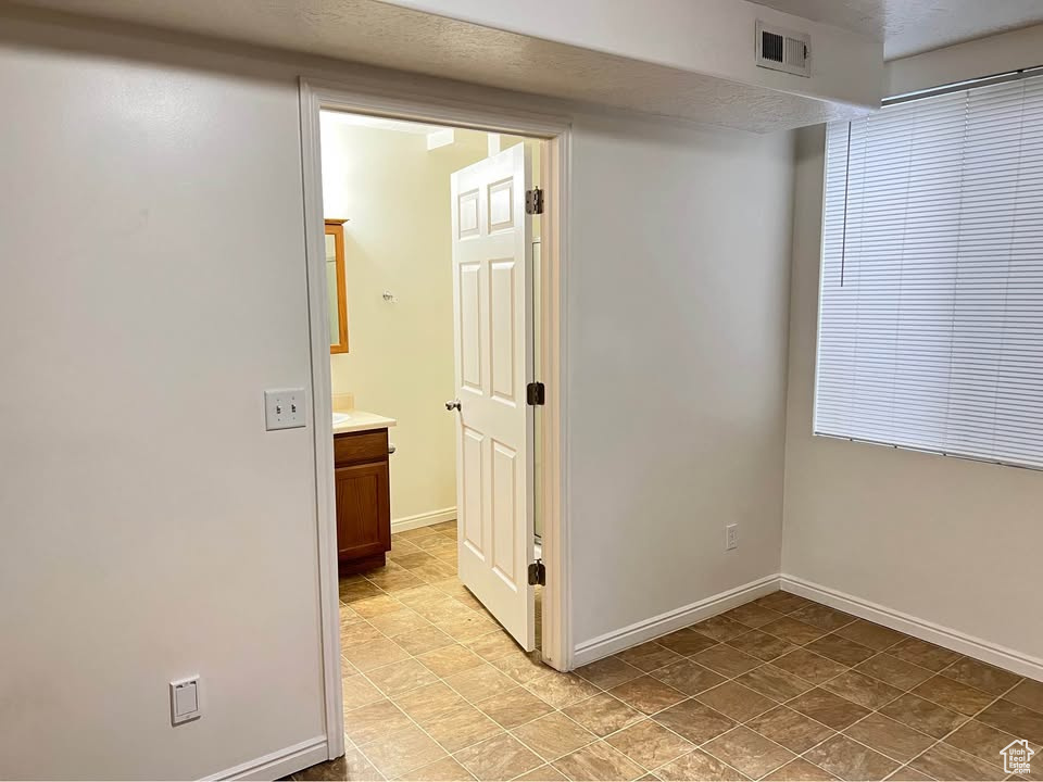 Unfurnished room with baseboards