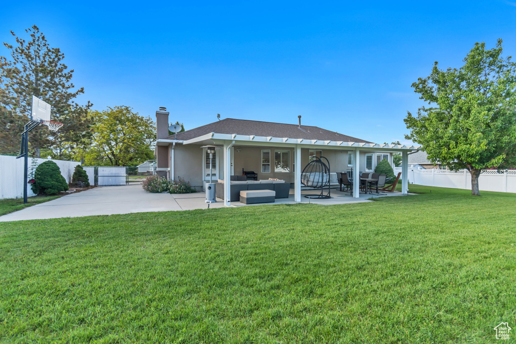 Rear view of house with an outdoor hangout area, a chimney, stucco siding, and a patio