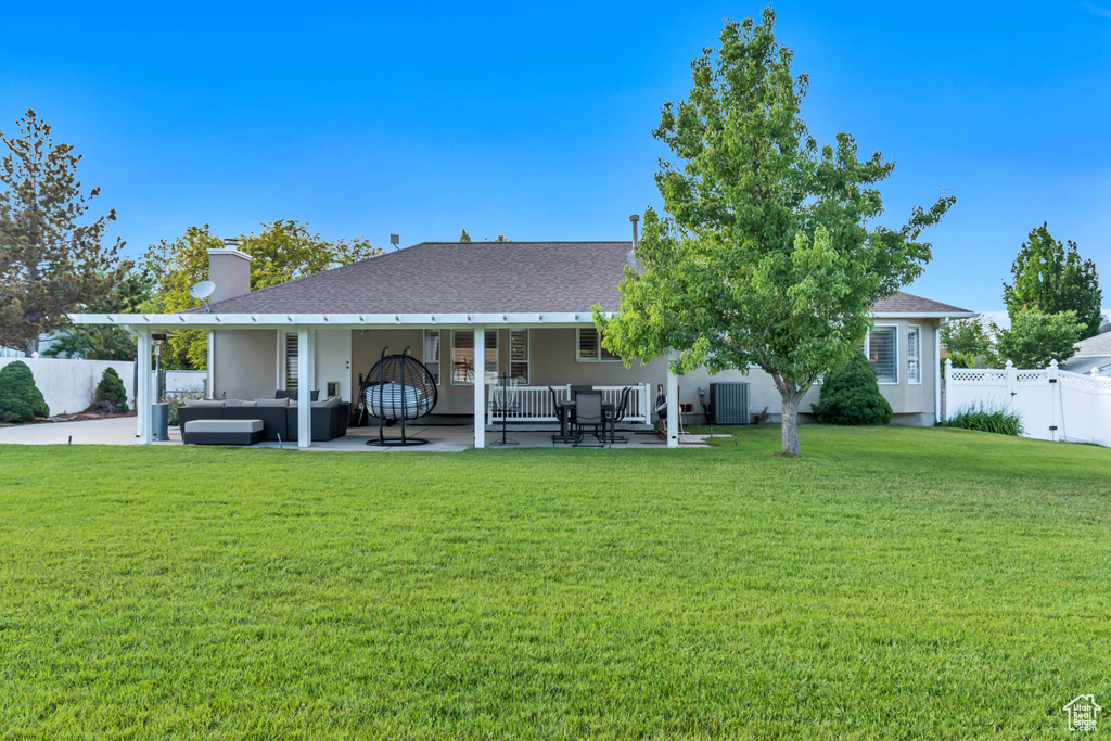 Rear view of property with outdoor lounge area, central AC, a patio area, and stucco siding