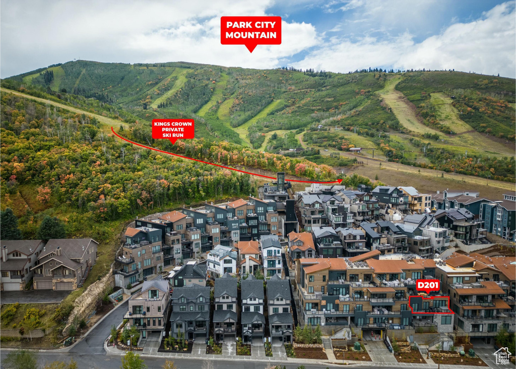 Aerial view of property and surrounding area with a mountainous background