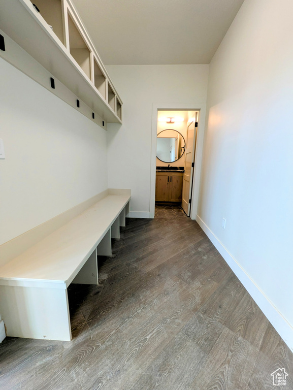 Mudroom featuring baseboards and wood finished floors