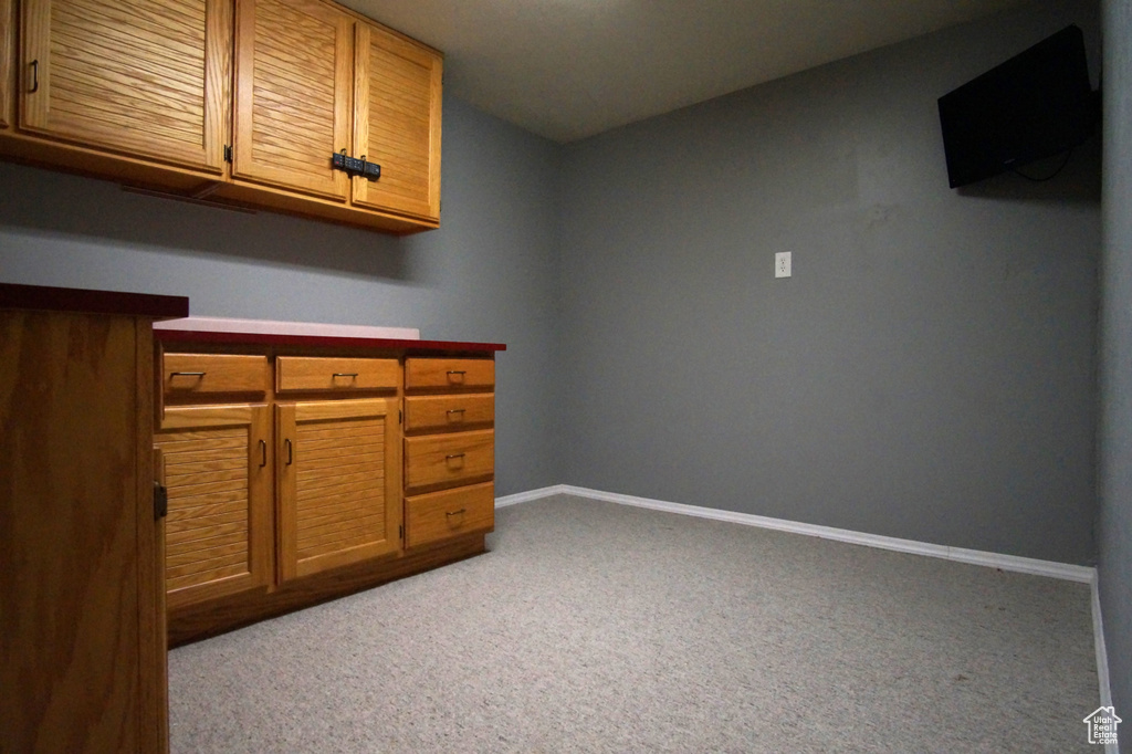 Interior space featuring baseboards and light colored carpet