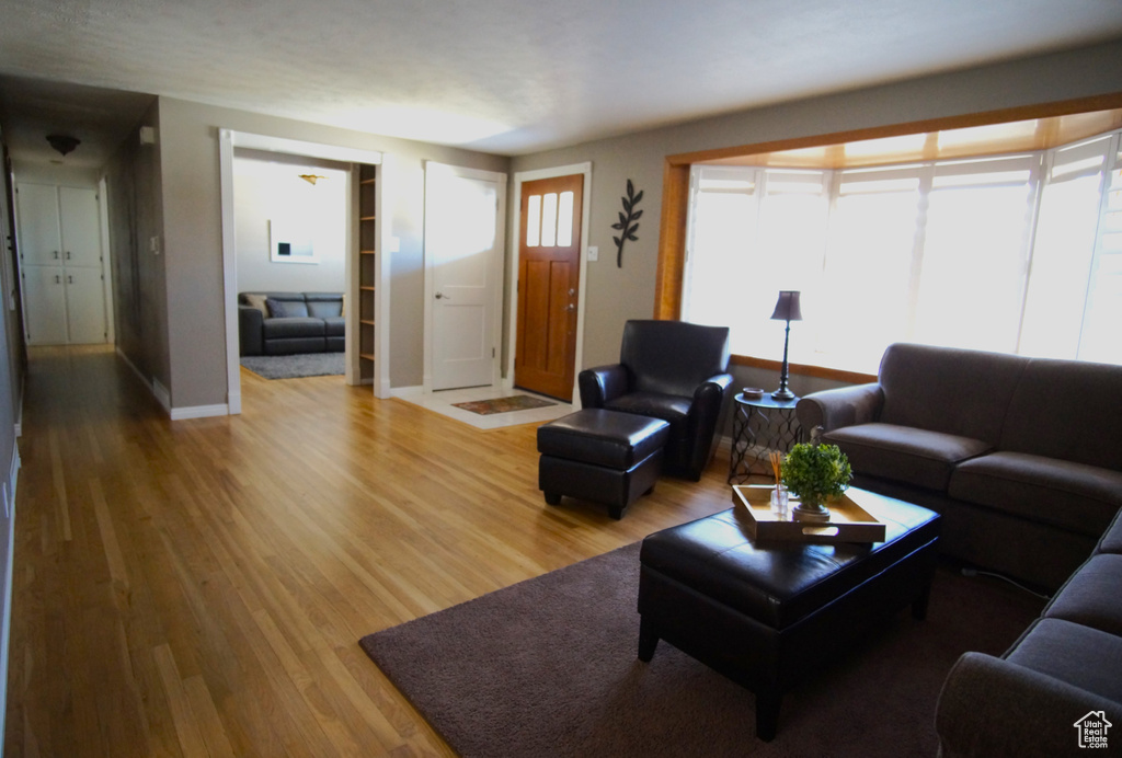 Living room with baseboards and light wood-style flooring