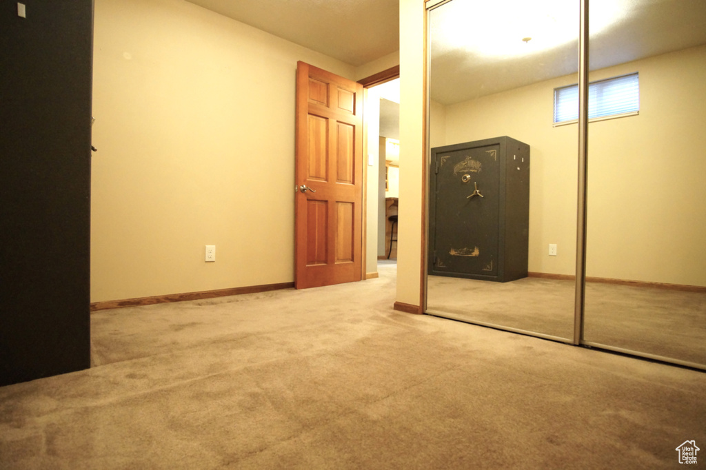 Unfurnished bedroom featuring a closet, baseboards, and carpet