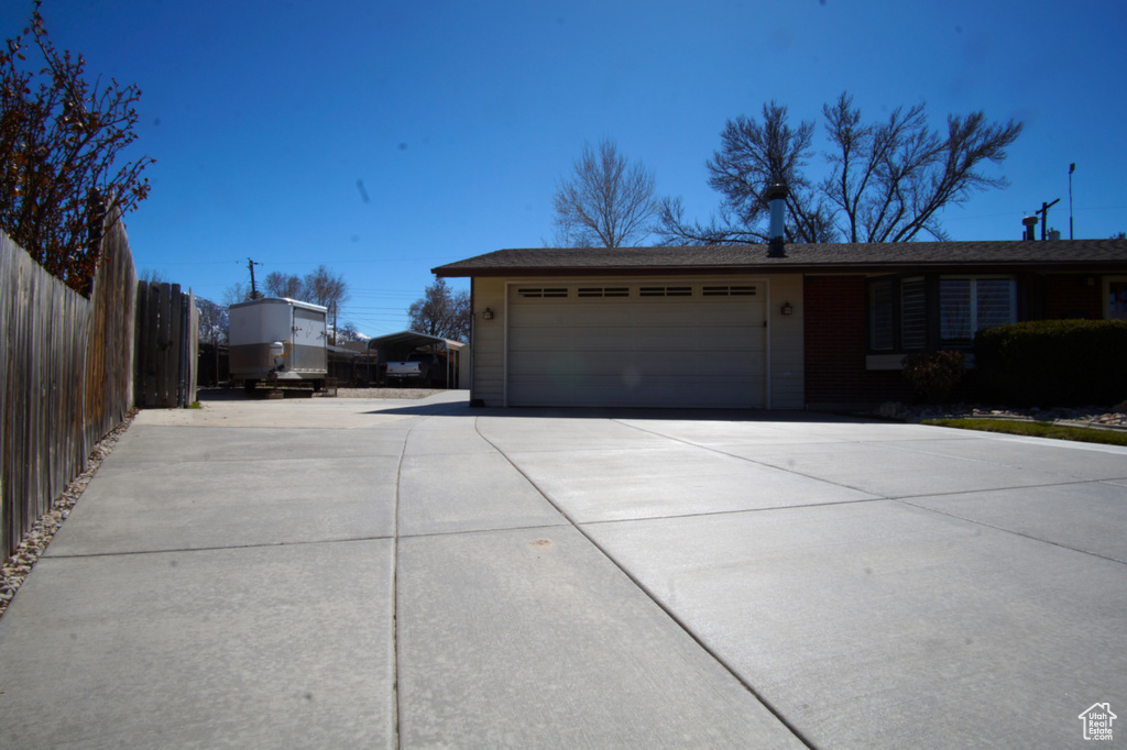 Exterior space featuring fence and concrete driveway