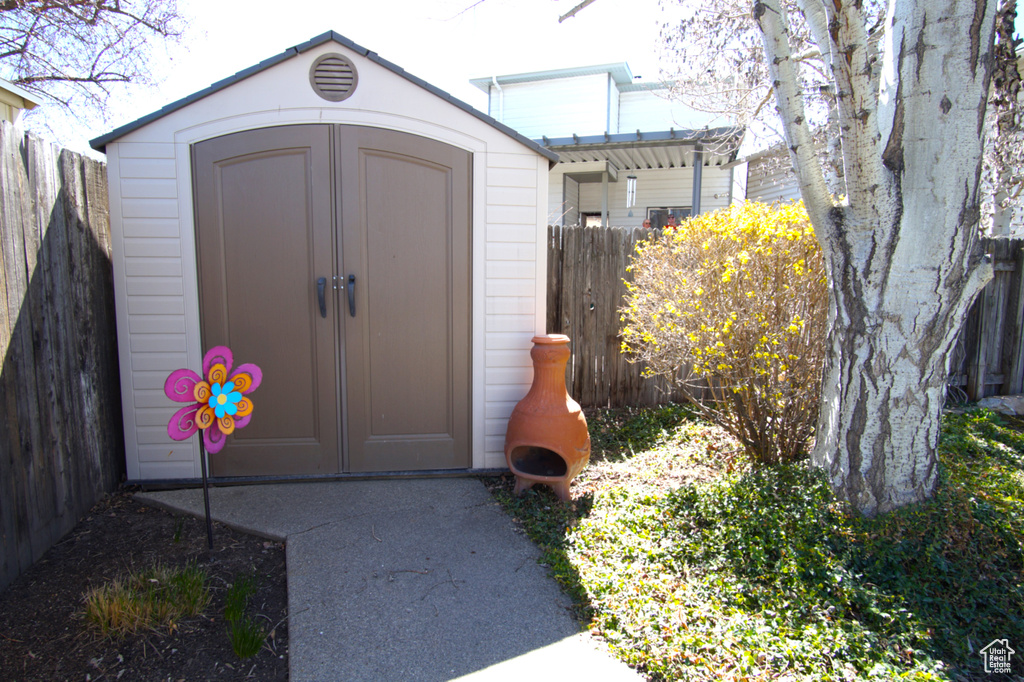 View of shed featuring fence