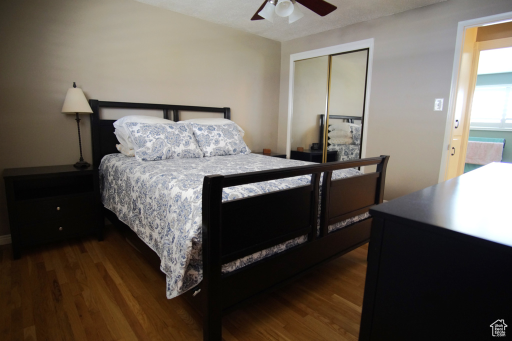 Bedroom featuring a closet, wood finished floors, and a ceiling fan