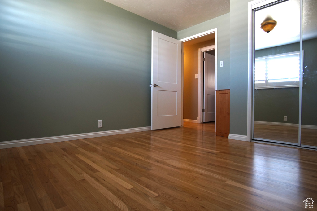 Unfurnished room featuring baseboards and wood finished floors
