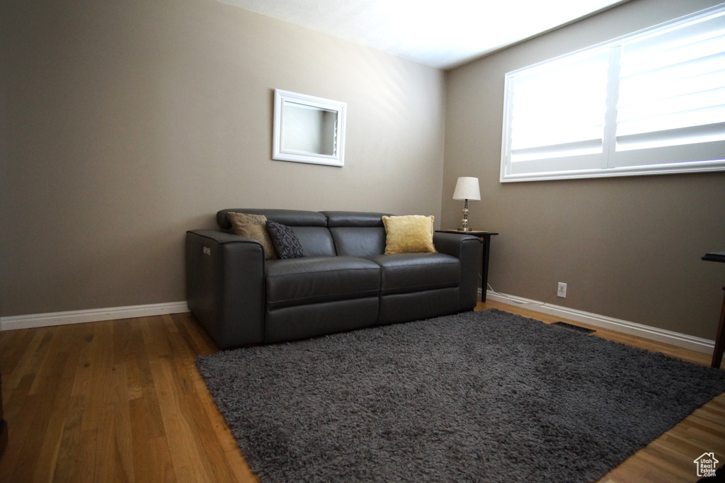 Living area featuring baseboards and wood finished floors