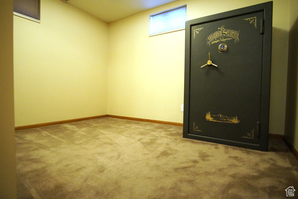 Basement featuring baseboards and carpet flooring