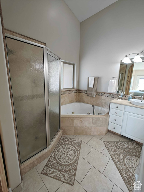 Full bath with vanity, tile patterned flooring, a whirlpool tub, and a shower stall