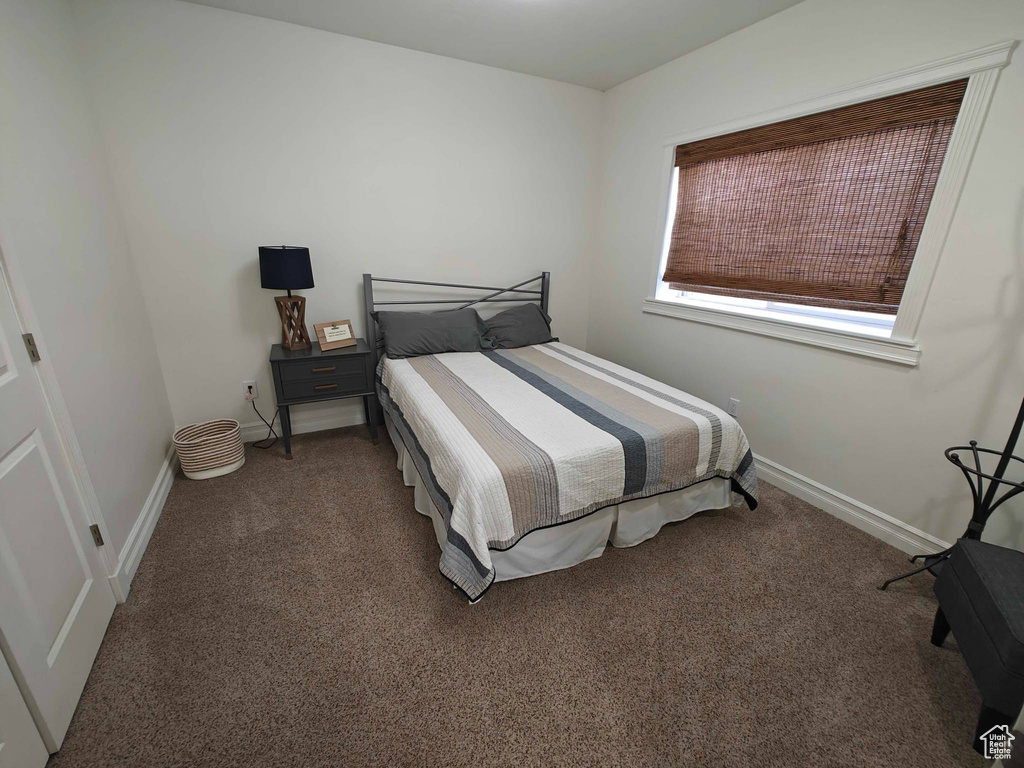 Bedroom with carpet floors and baseboards