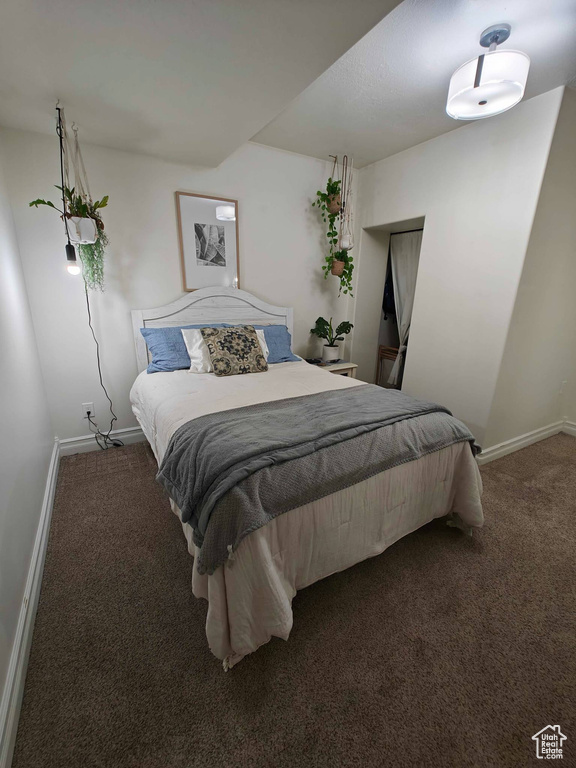 Carpeted bedroom with baseboards