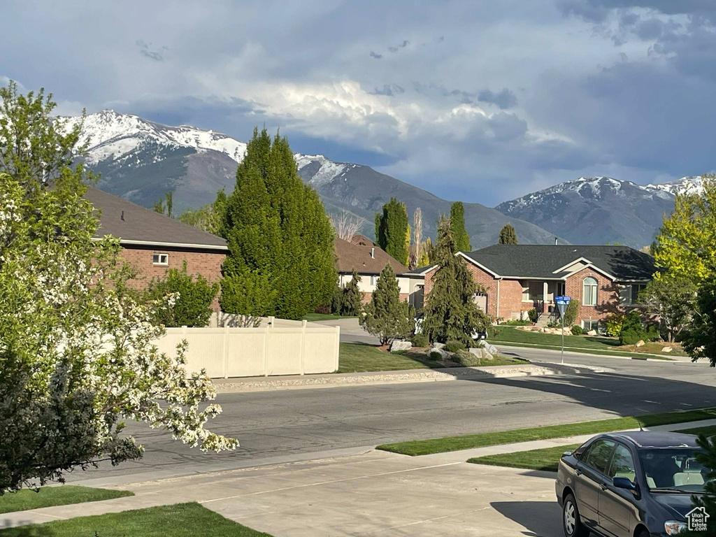 View of road with a residential view, sidewalks, and a mountain view