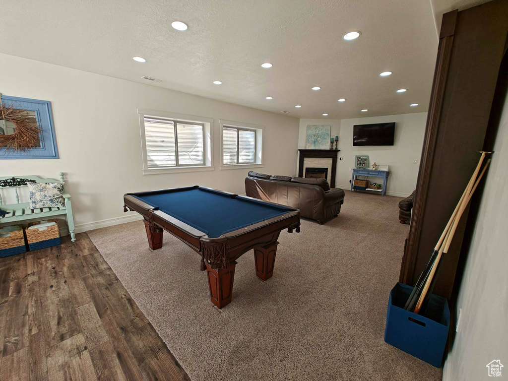 Game room featuring pool table, a fireplace, wood finished floors, baseboards, and recessed lighting