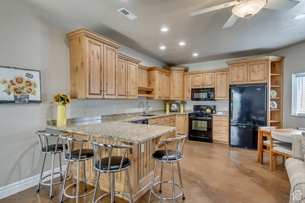 Kitchen featuring a sink, open shelves, a peninsula, visible vents, and black appliances