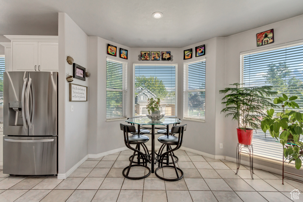 Dining room featuring light tile patterned flooring, baseboards, and recessed lighting