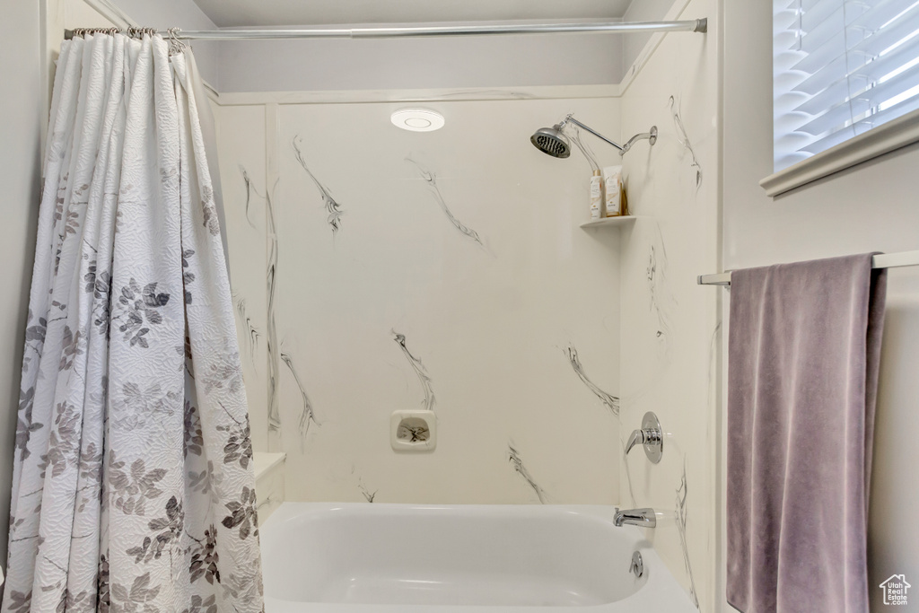 Full bathroom with shower / tub combo with curtain