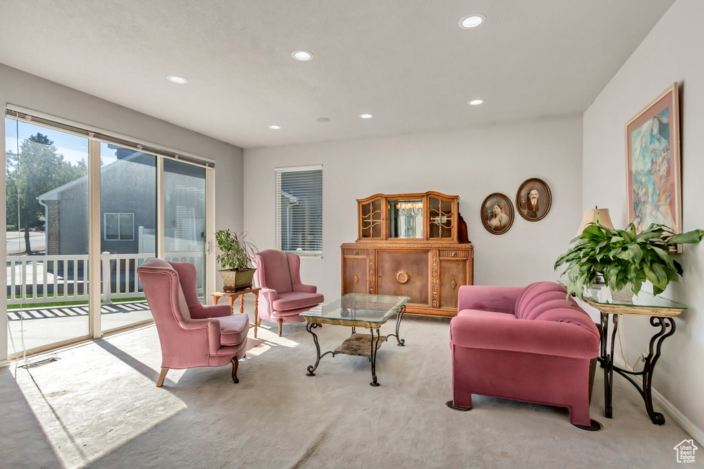 Carpeted living area with baseboards and recessed lighting