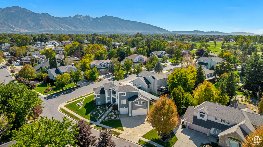 Birds eye view of property with a mountain view and a residential view
