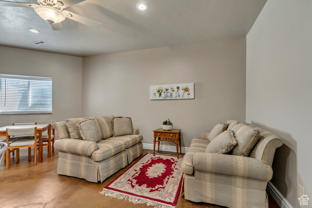 Living area with recessed lighting, concrete floors, baseboards, ceiling fan, and visible vents