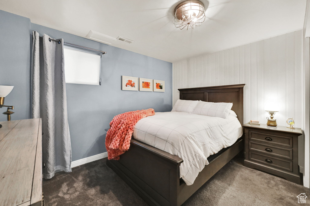 Carpeted bedroom featuring baseboards and visible vents