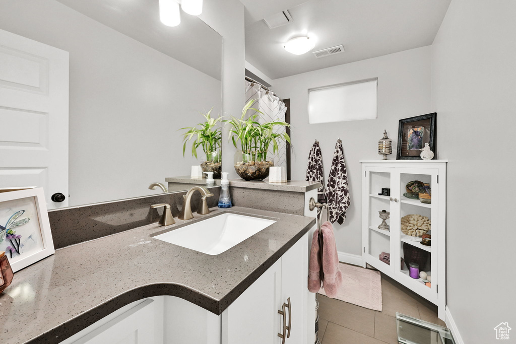 Full bathroom with visible vents, tile patterned flooring, and vanity