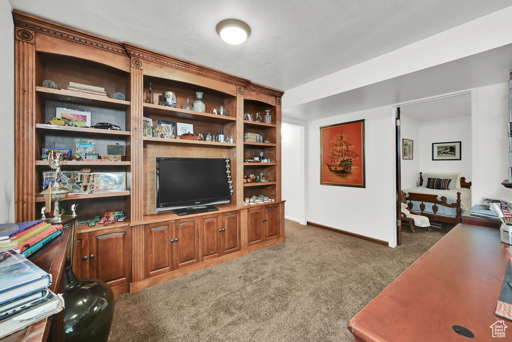 Carpeted office space featuring baseboards