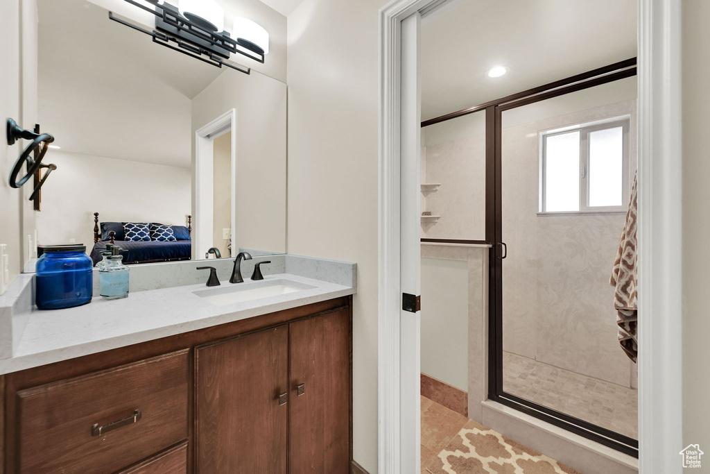 Ensuite bathroom with vanity, ensuite bathroom, and a shower stall