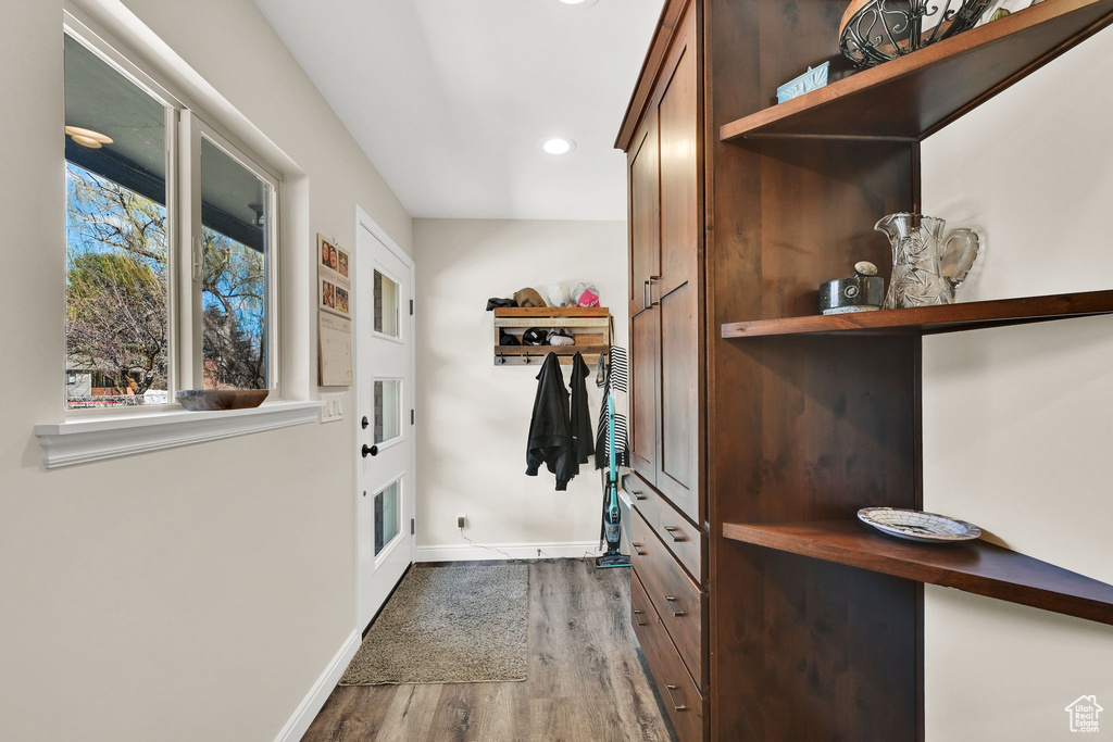 Doorway featuring baseboards, recessed lighting, and dark wood-style flooring