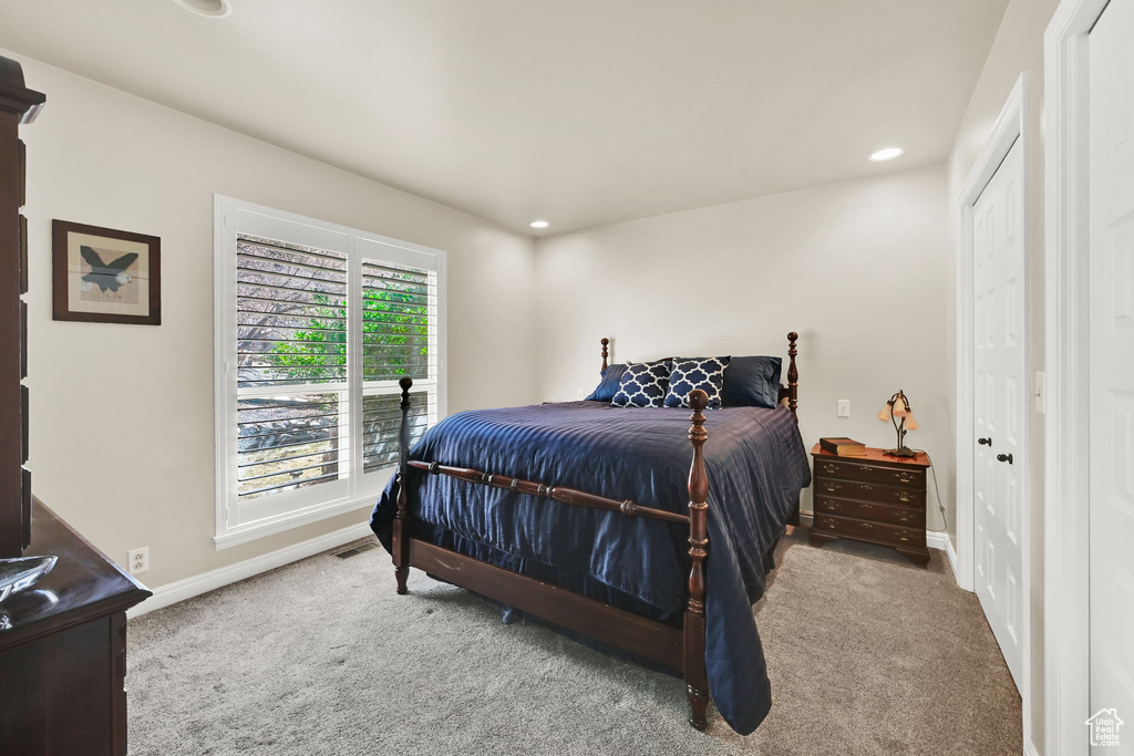 Carpeted bedroom with baseboards and recessed lighting