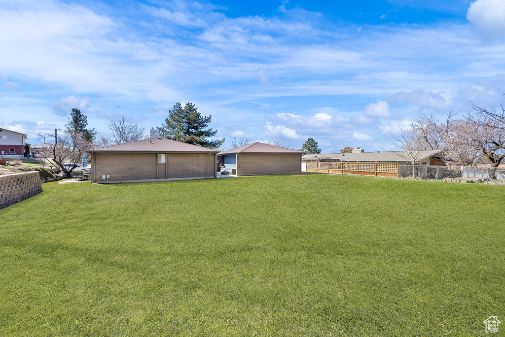 View of yard featuring fence