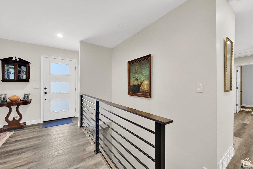 Entryway featuring baseboards, wood finished floors, and recessed lighting