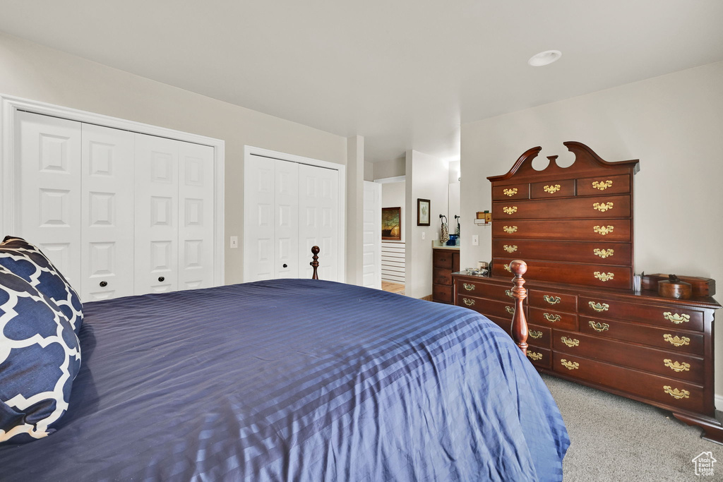 Bedroom with carpet floors and multiple closets