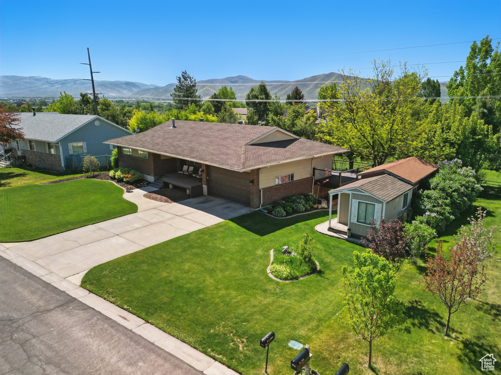 Aerial view of property and surrounding area with a mountainous background