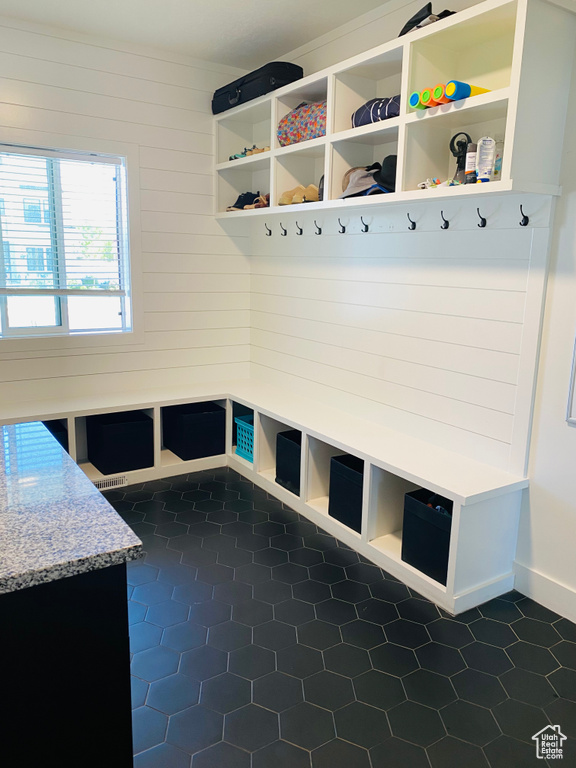 Mudroom with dark tile patterned flooring and visible vents