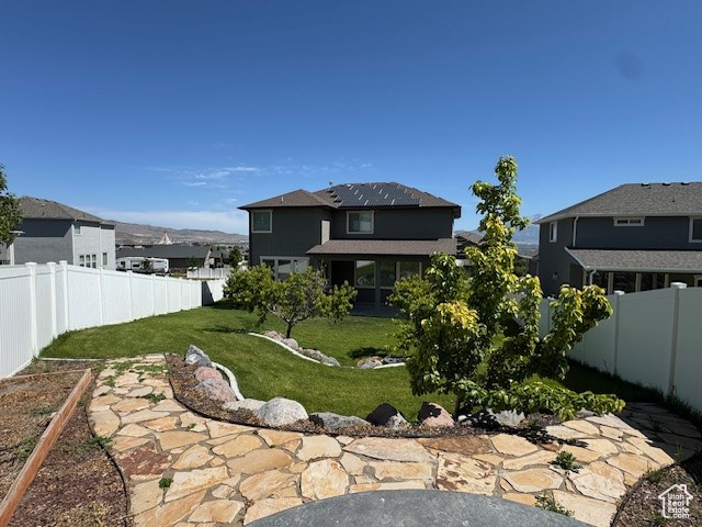 Fenced backyard with a residential view