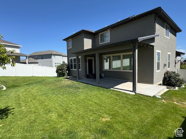 Back of house featuring stucco siding and a patio area