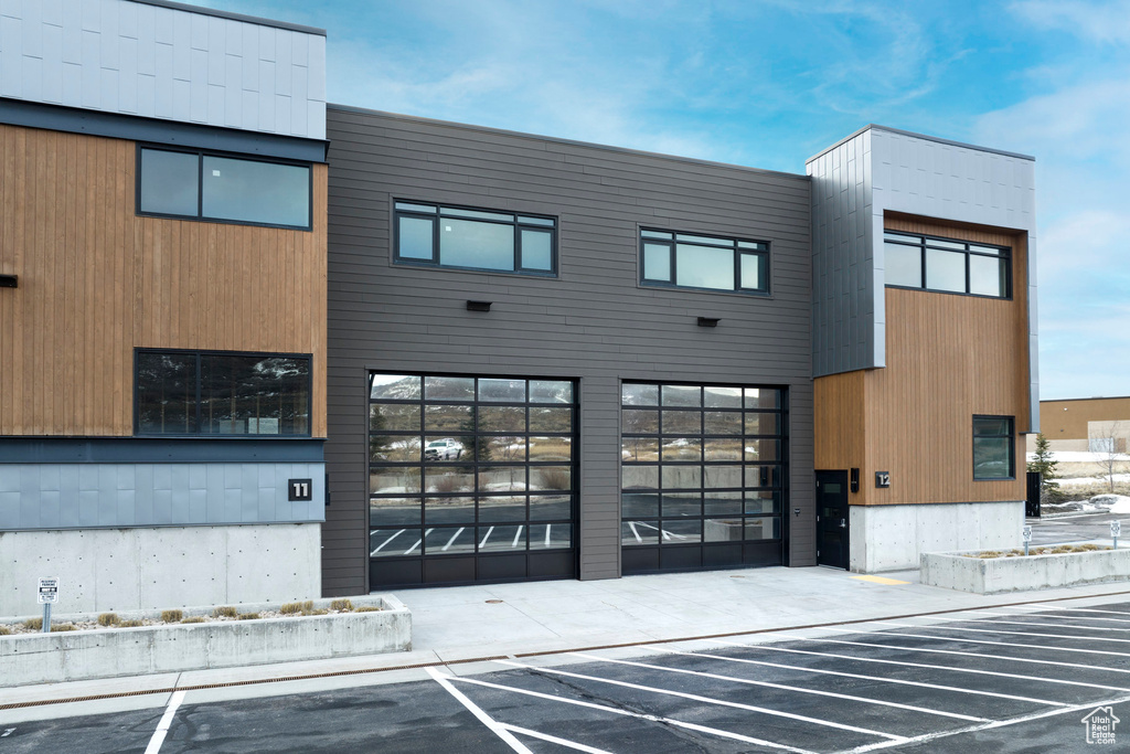 View of building exterior with uncovered parking