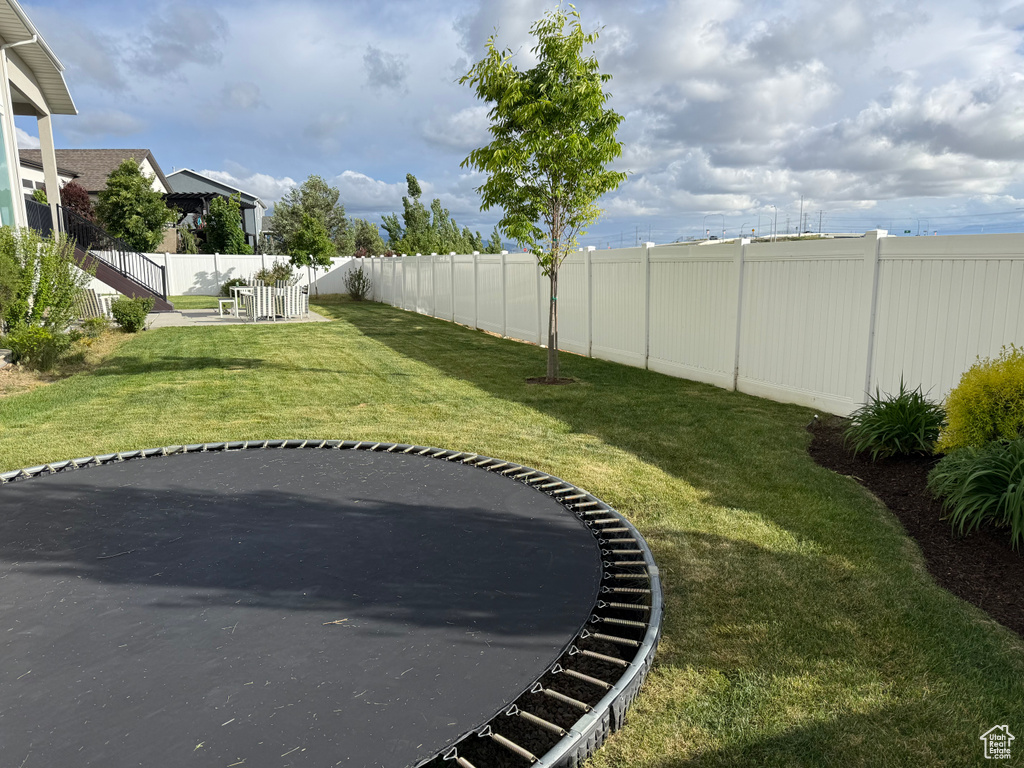 View of yard with a trampoline