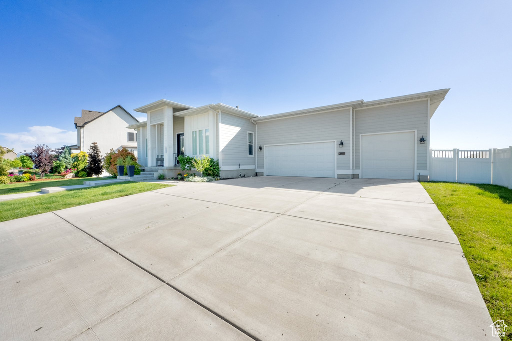 View of front of home with a garage and concrete driveway