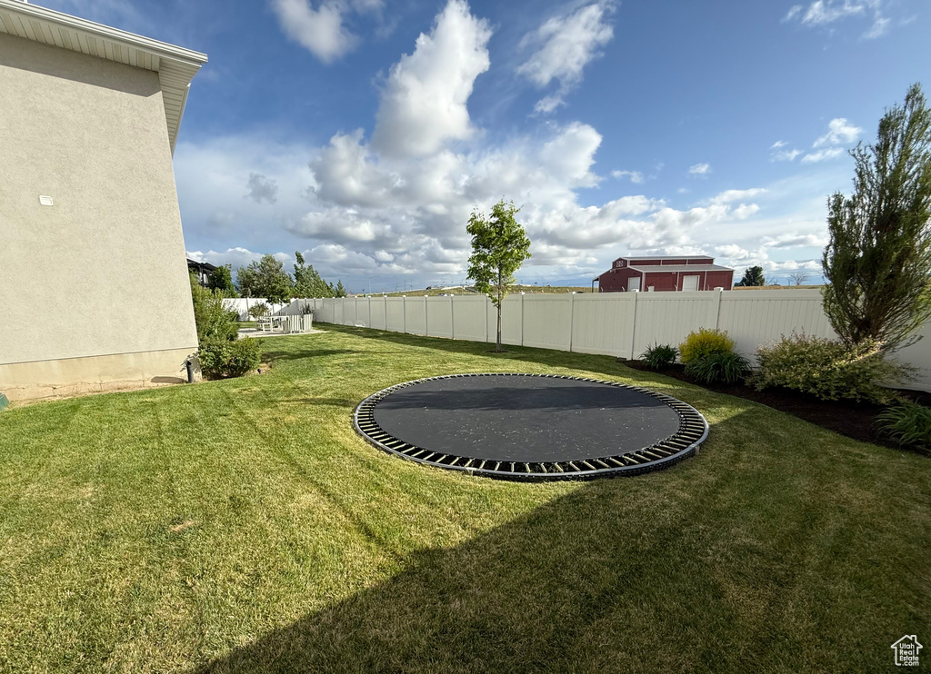 View of yard featuring a trampoline