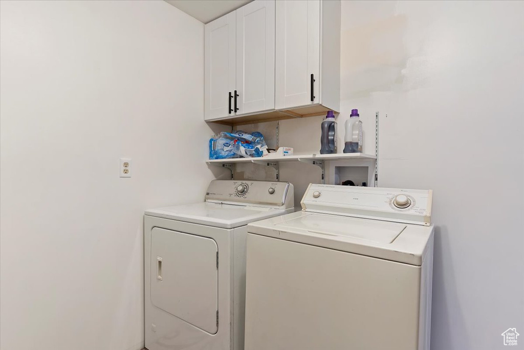 Laundry room with washing machine and clothes dryer and cabinet space