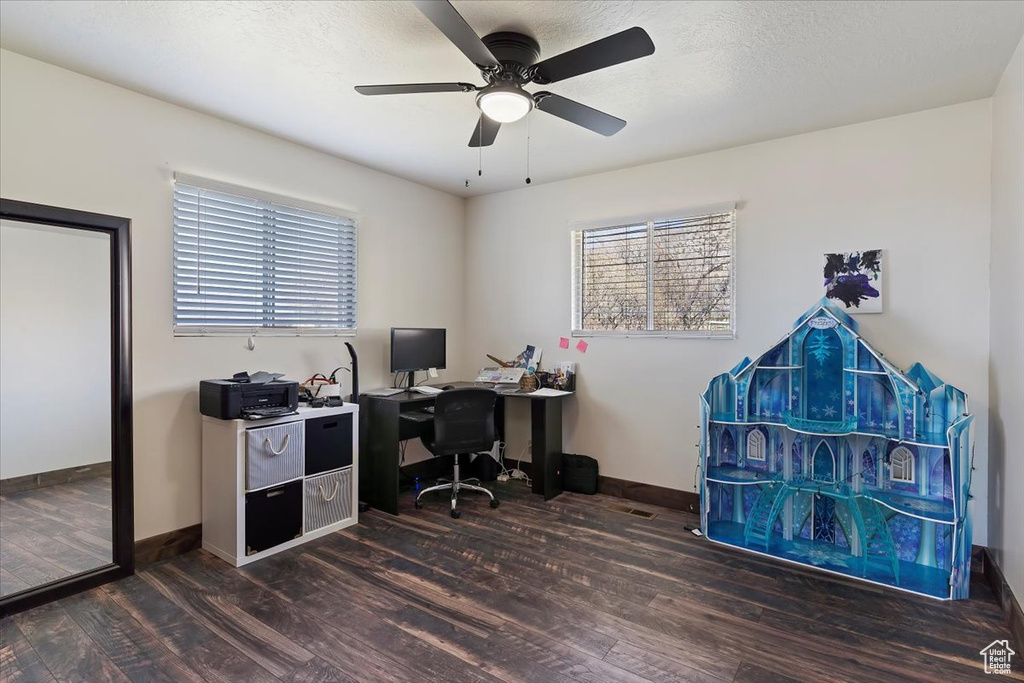 Office with baseboards, a textured ceiling, wood finished floors, and a ceiling fan